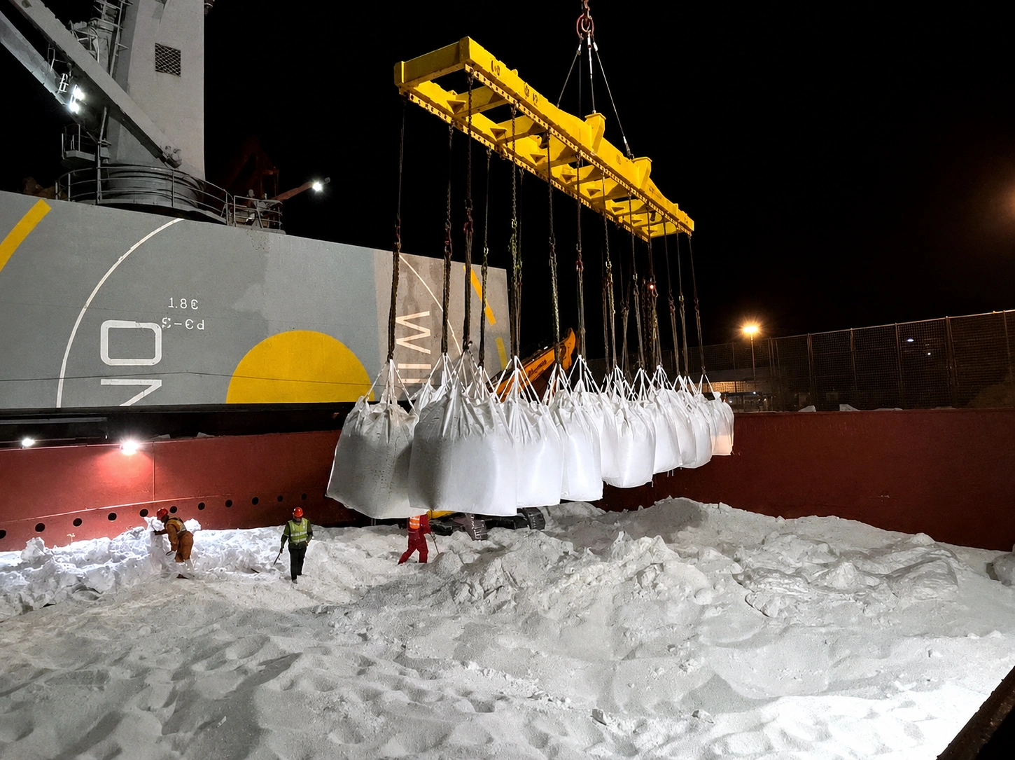 Bulk cargo bags being transferred from a vessel at night